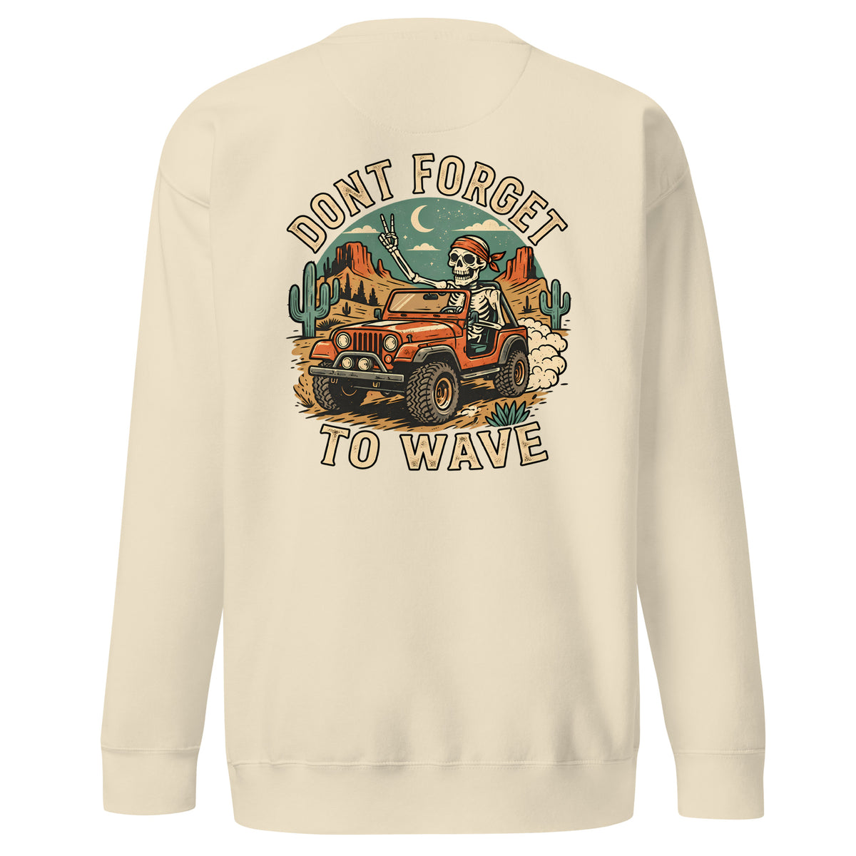 A cream-colored crewneck sweatshirt shown from the back, featuring a large graphic print of a skeleton driving an orange jeep through a desert landscape with cacti and the text 'DONT FORGET TO WAVE'.
